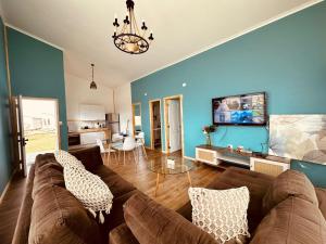 a living room with a brown couch and blue walls at Cabañas Arte Brisa in Puerto Natales