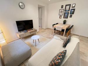 a living room with a couch and a table at Charming house 2BR, 100m to RER B Laplace station in Arcueil