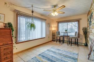 a living room with a ceiling fan and a table at Montour Falls Apartment about 3 Mi to Seneca Lake! in Montour Falls