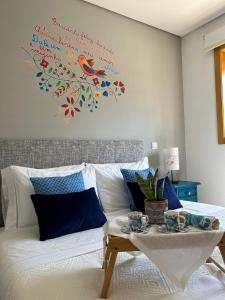 a living room with a couch with a bird on the wall at Fontainha House & SPA in Caldelas +19 photos
