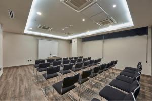 a conference room with chairs and a podium at City Express Plus by Marriott Tampico in Tampico