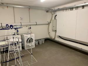 a laundry room with a dishwasher and a drying rack at Villa Meeresrauschen Carpe Diem mit großzügiger Terrasse und extragroßem Strandkorb in Pelzerhaken