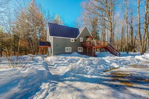 a house in the snow with a lot of snow at Sugarbush Ski Getaway - Lower in Warren