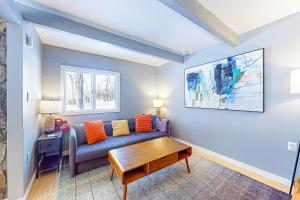 a living room with a couch and a table at Sugarbush Ski Getaway - Lower in Warren