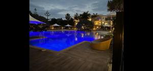 a large swimming pool with blue water at night at Cosy Hotel Room with plunge pool at Kingscliff Salt Beach Resort and Spa in Kingscliff