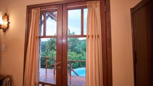 a window with a view of a car outside at El vergel de la Sierra in Sierra de los Padres