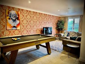 a living room with a pool table in it at 5 Bedroom House-Sleeps 13-Big Savings On Long Stays! in Colchester