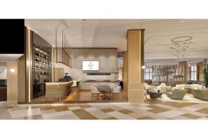 a lobby of a hotel with white chairs and tables at Delta Hotels Istanbul West in Istanbul