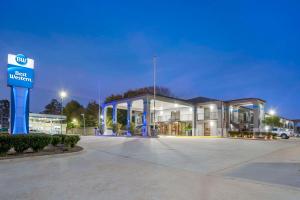 a building with a sign in a parking lot at Best Western Andalusia Inn in Andalusia