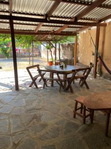 a picnic table and benches on a patio at Hotel Pacific Surf Tunco Beach best Room Surf City in La Libertad