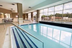 a swimming pool with blue water in a building at Drury Inn & Suites Mt. Vernon in Mount Vernon