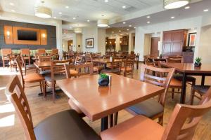 a dining room with wooden tables and chairs at Drury Inn & Suites Phoenix Tempe in Tempe
