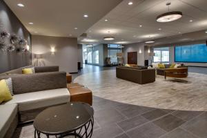 a lobby with couches and tables in a building at Drury Plaza Hotel Cape Girardeau Conference Center in Cape Girardeau