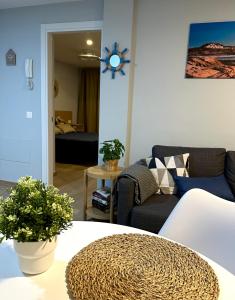 a living room with a couch and a table at Apartamento El Faro del Cabezo in Arona +9 photos