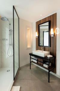 a bathroom with a sink and a mirror at Radisson Hotel Tunis, City Center in Tunis