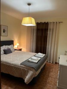 a bedroom with a bed with towels on it at Alojamento, Chelas Rural AL in Mirandela
