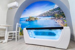 a bathtub with a view of a beach at AC HOME in Catania