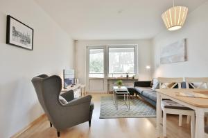 a living room with a couch and a table at Haus Hubertus Haus Hubertus Appartement 05 in Niendorf