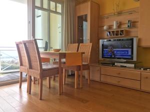 a dining room with a table and a tv at Meerblickvilla Prinz Heinrich - Ferienwohnung 4 in Sassnitz