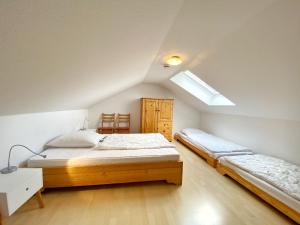 - une chambre mansardée avec 2 lits et une lucarne dans l'établissement Ferienwohnung Osterholz, à Baabe