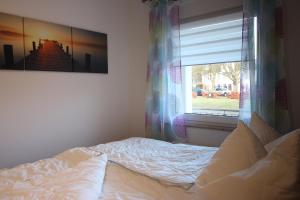 Postel nebo postele na pokoji v ubytování Kurparkcarree - Ferienwohnung Meeresbrise