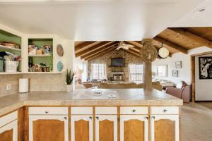 a kitchen with a counter and a living room at Casa Venado in Coarsegold