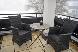 a table and two chairs on a balcony with a table at Winterberg Appartement 21114 in Winterberg