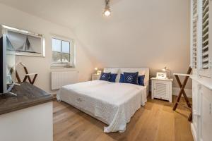 a bedroom with a bed with blue pillows on it at Designhaus Freyh II in Ranzow