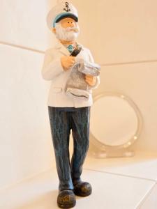 a plastic figurine of a man holding at _ARW3_ _ Ferienwohnung Kossmann in Niendorf