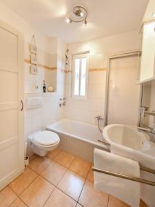 a bathroom with a tub and a toilet and a sink at _ARW3_ _ Ferienwohnung Kossmann in Niendorf