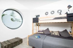 a bedroom with a bunk bed and a mirror at _ERL41_ PIER 41 in Niendorf