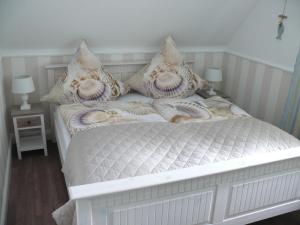 a white bed with pillows on it in a room at Wik7A in Niendorf