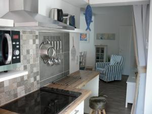 a kitchen with a stove top oven in a room at Wik7A in Niendorf