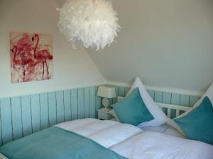 a bedroom with a bed and a chandelier at Wik7B in Niendorf