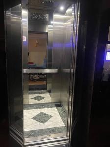 a glass cabinet with a tile floor in a room at BLUE SKY GUEST HOUSE in Phnom Penh