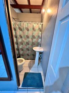a small bathroom with a toilet and a sink at Hotel Pacific Surf The Best Room in Tunco Beach Surf City in Tamanique