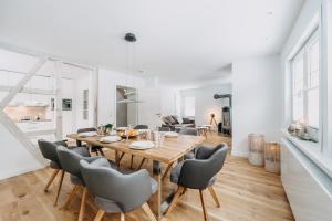 a dining room and living room with a table and chairs at Villa Luna Braunlage in Braunlage