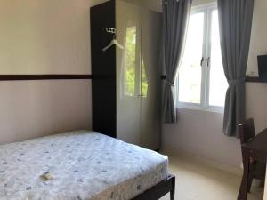a bedroom with a bed and a window at akhemy homestay in Tangerang