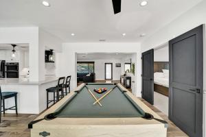 a pool table in the middle of a living room at Once Upon a Tide - Just Minutes to the Beach in Dania Beach