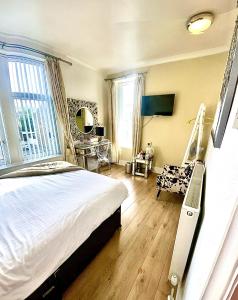 a bedroom with a bed and a chair in it at Highfield Guesthouse in Skipton