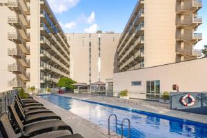 a swimming pool in front of a building at V's Cosy Retreat in Broadview