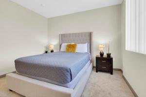 a bedroom with a large bed and a night stand at San Diego 2 Bedroom Walk to the Mall in San Diego