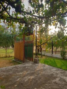 a playground in a park with a tree at San Mamas Seaside Cottage-House, Large Garden and Caravan in Agios Mamas