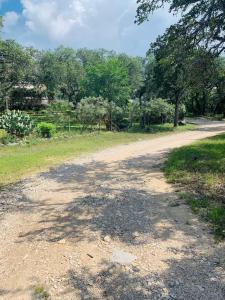 a dirt road in the middle of a field at Mosaic On The Hill in San Marcos