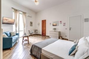 - une chambre avec un lit et un canapé bleu dans l'établissement Le Mura Antiche, à Naples
