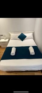 a large white bed with two pillows on it at Hidden Gem at Luxurious Ocean Village in Gibraltar