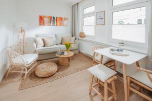 sala de estar con sofá y mesa en Villa Fresena Bude 9, en Norderney