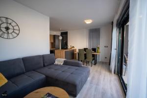 a living room with a couch and a dining room at Holiday house with a parking space Vir - 22303 in Vir