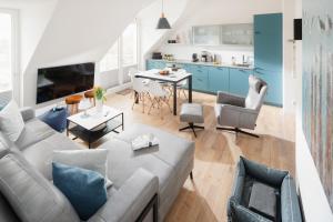 a living room with a couch and a table at Quartier M12 in Norderney