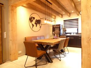 a dining room with a wooden table and chairs at Chalet Luxury Winterberg Ferienwohnung 6 Pers Wifi 3xSchlafzimmer near Bikepark in Winterberg
